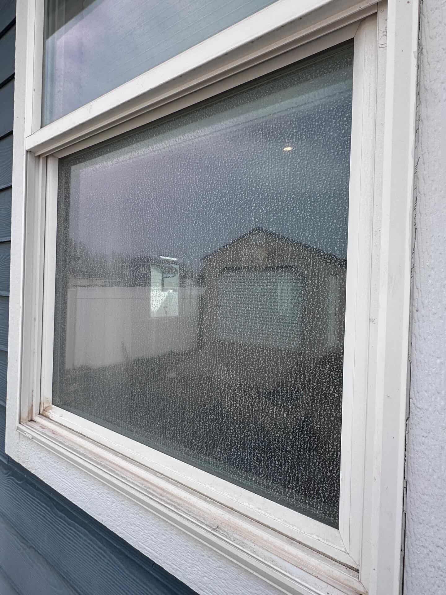 Dirty residential window before professional cleaning in East Wenatchee