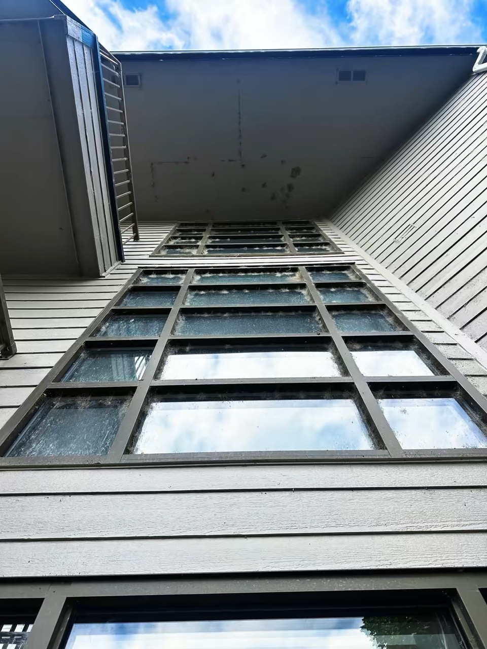 Multi-story commercial windows with heavy buildup before cleaning in Wenatchee Valley