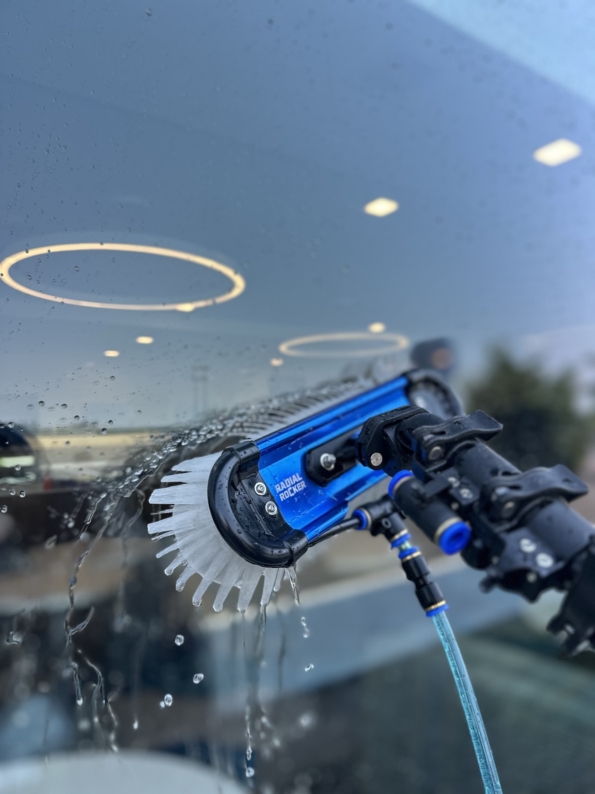 Professional water-fed window cleaning brush working across commercial glass