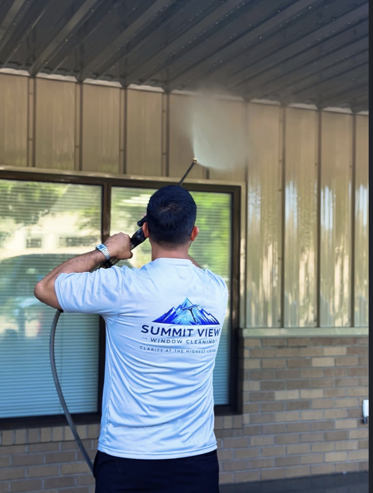 Summit View technician power washing an exterior surface in Wenatchee, WA